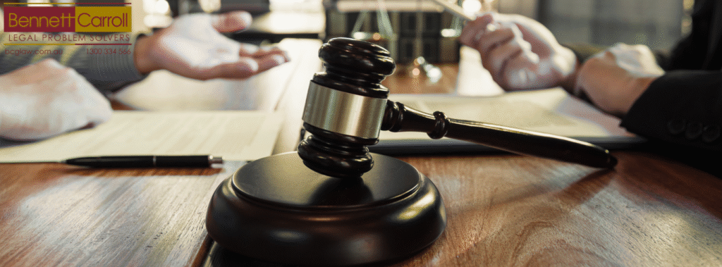 Professionals in a legal office reviewing court documents and discussing dispute resolution—representing civil litigation, legal disputes, and court proceedings in Queensland, including business disputes, contract breaches, and neighbour conflicts, handled by experienced Queensland litigation lawyers.